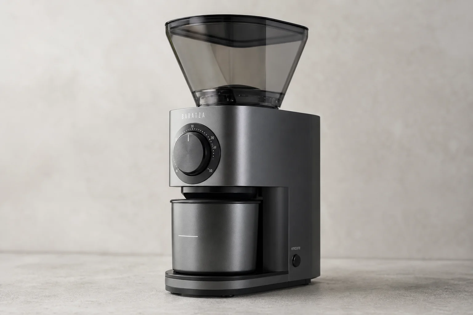 Five coffee grinders from budget electric to commercial bulk models arranged on concrete