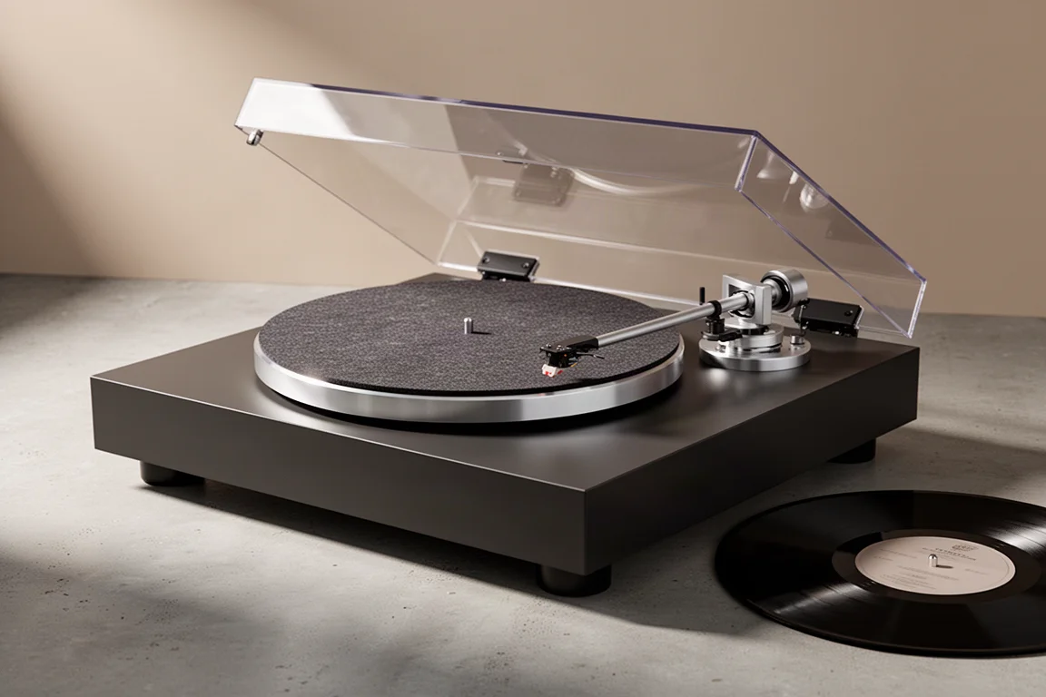 Belt-drive turntable with matte dark grey plinth and aluminium top plate on concrete
