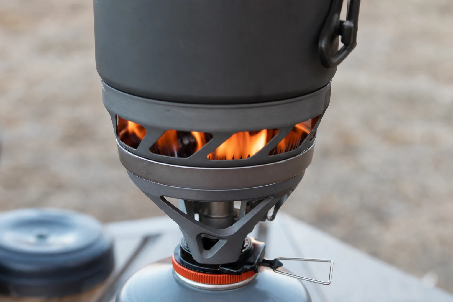 Jetboil stove with orange flame indicating boiled water