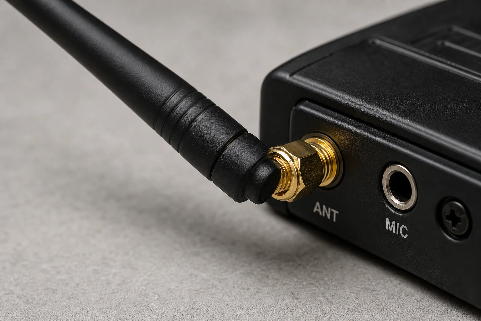 Close-up of SMA antenna connector on radio equipment with short whip antenna