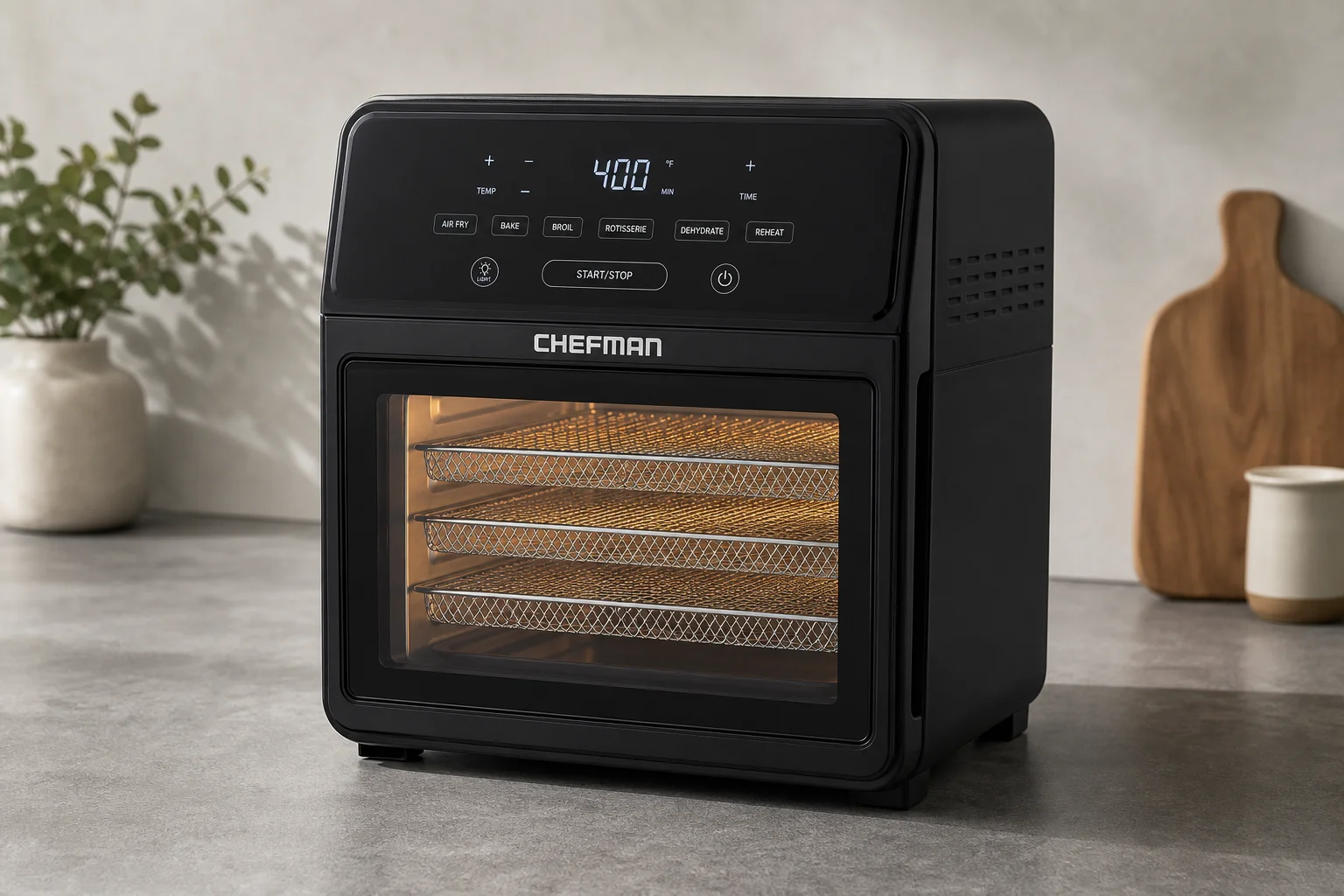 Seven air fryers of varying sizes and designs arranged on a neutral surface