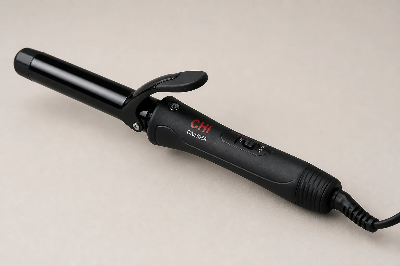 Five curling irons in various sizes arranged on a marble surface