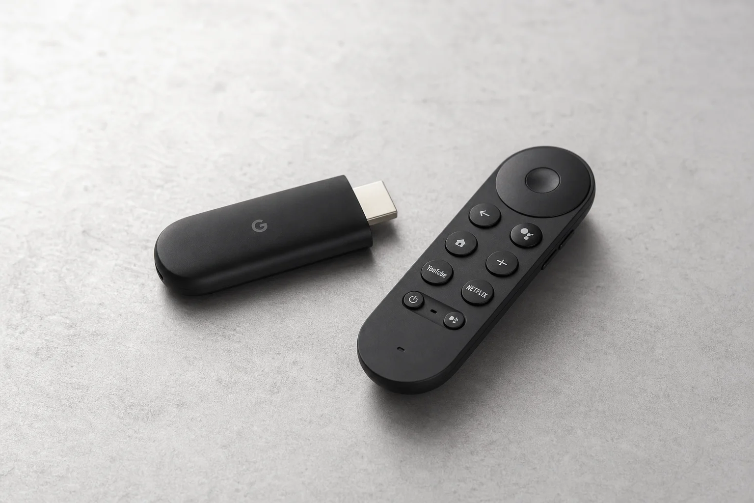 Collection of black Android TV boxes on neutral grey surface showing various form factors