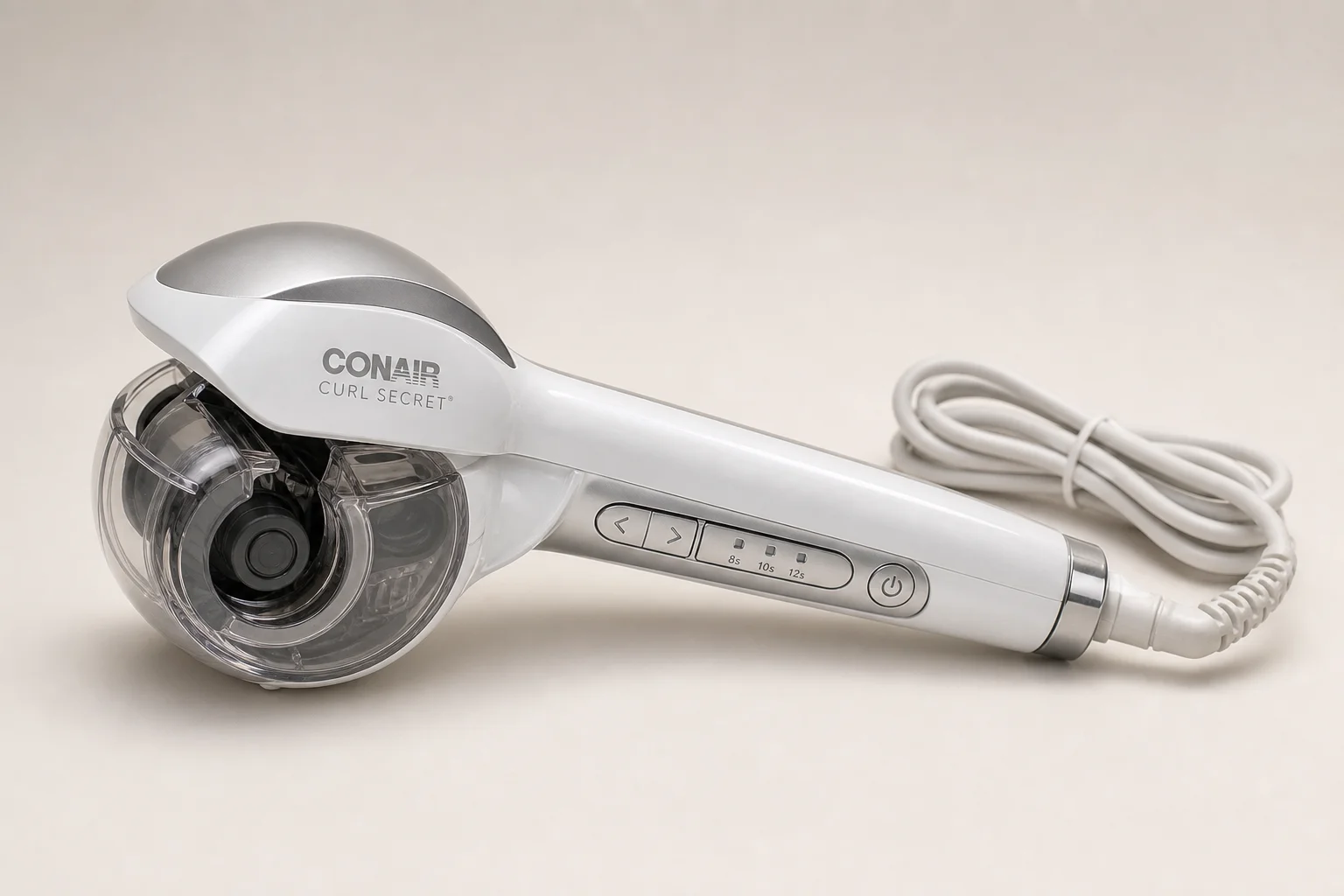 Conair Curl Secret automatic hair curler on neutral backdrop with transparent chamber visible