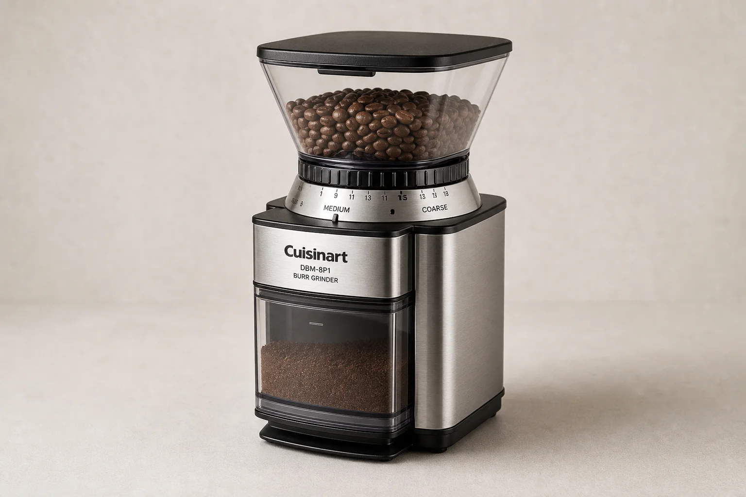 Five coffee grinders arranged by size on a concrete surface