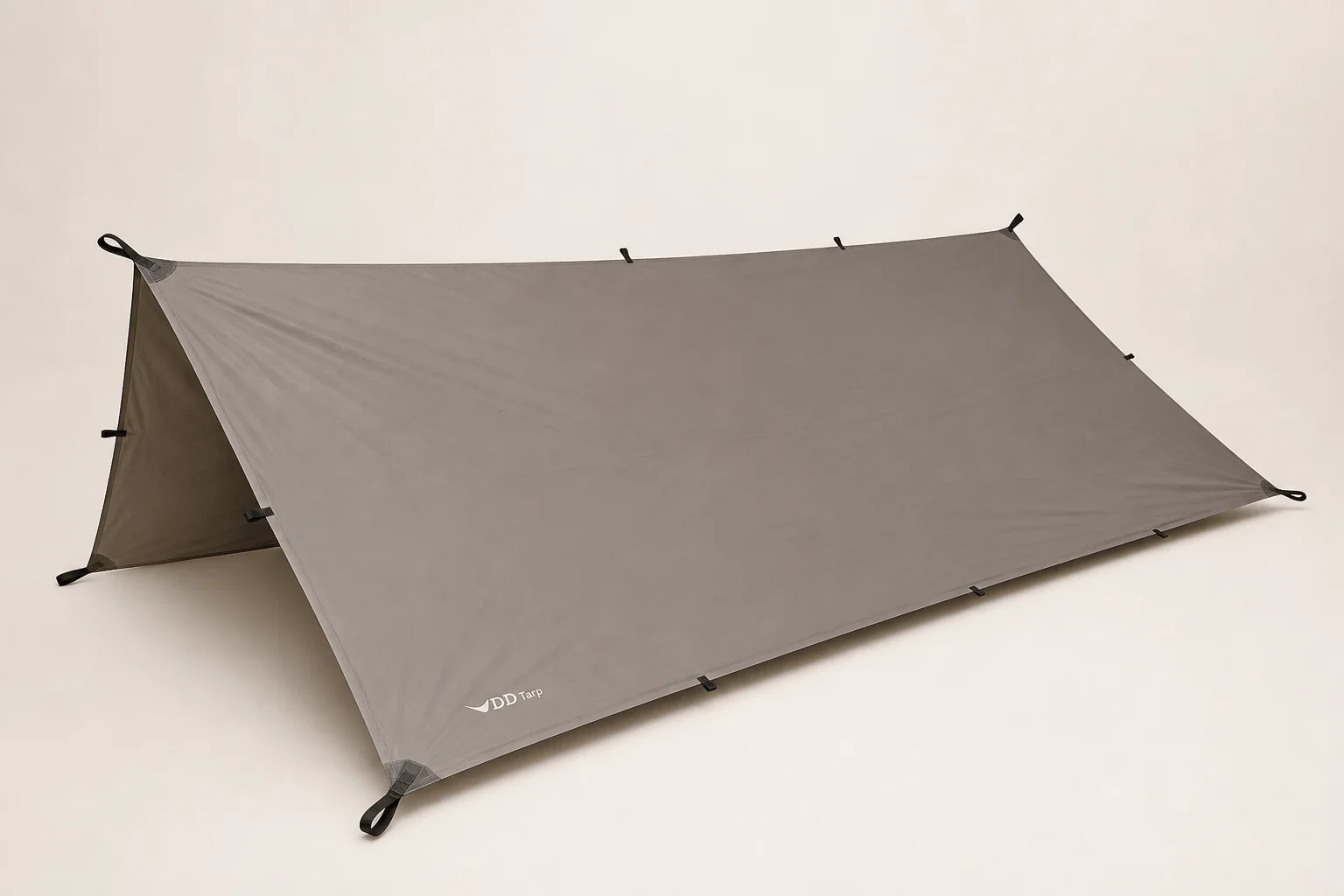 Five trekking tarps displayed side by side showing different designs and colors