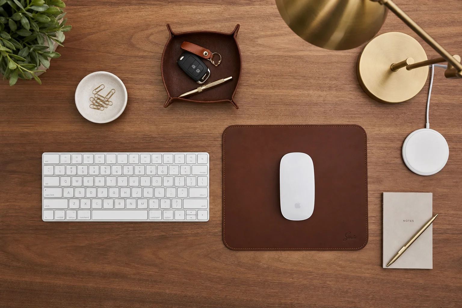 Desk accessories including keyboard, mouse, mousepad, and desk lamp arranged on workspace