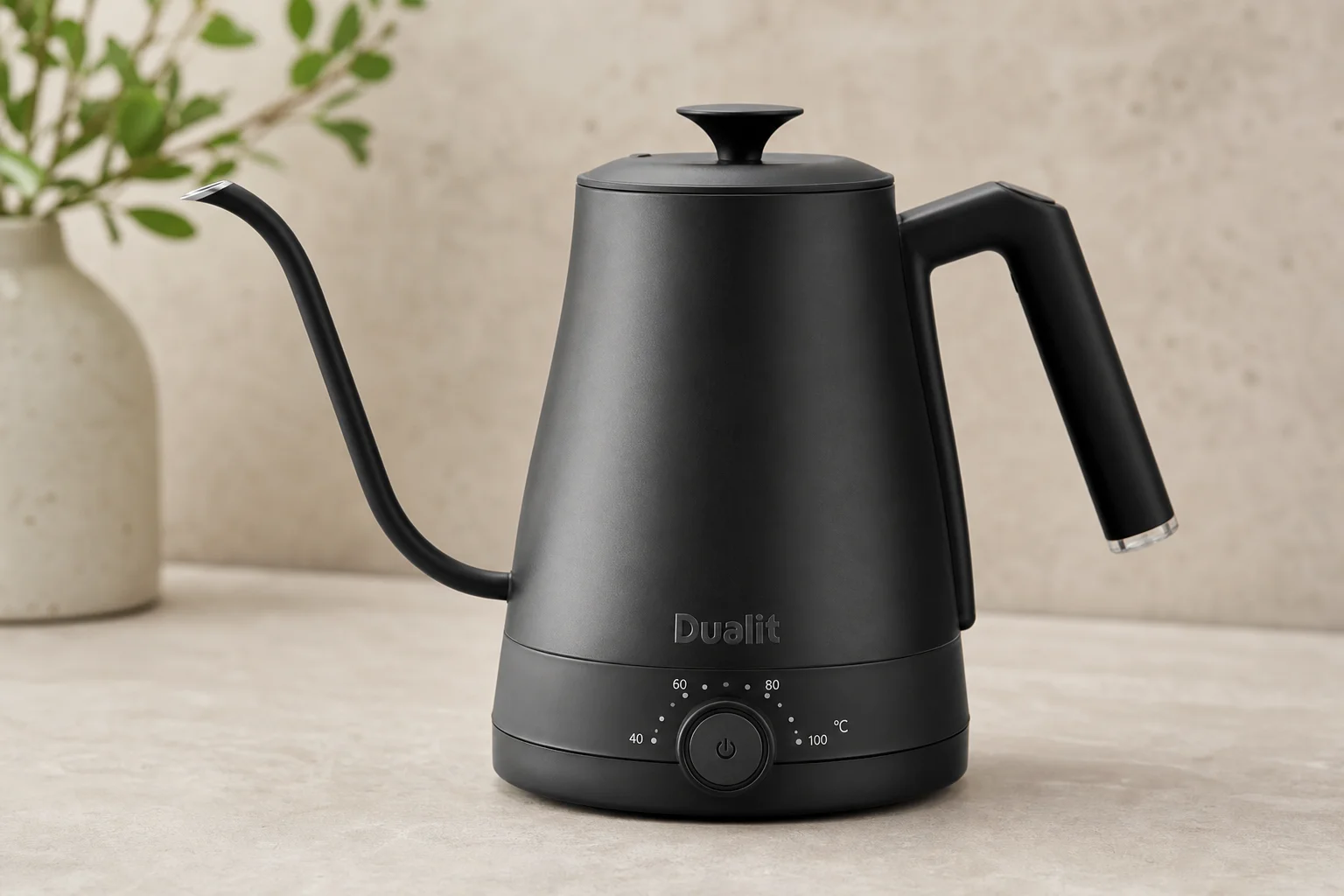 Eight electric gooseneck kettles arranged on concrete surface showing different designs and finishes