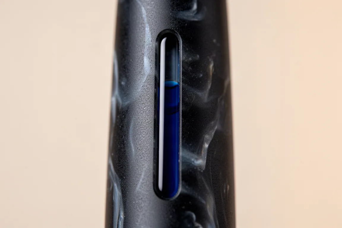 Close-up of the narrow ink window on a fountain pen barrel showing ink level