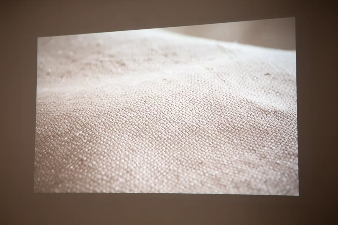 Close-up of woven fabric texture in a projected image on a screen surface