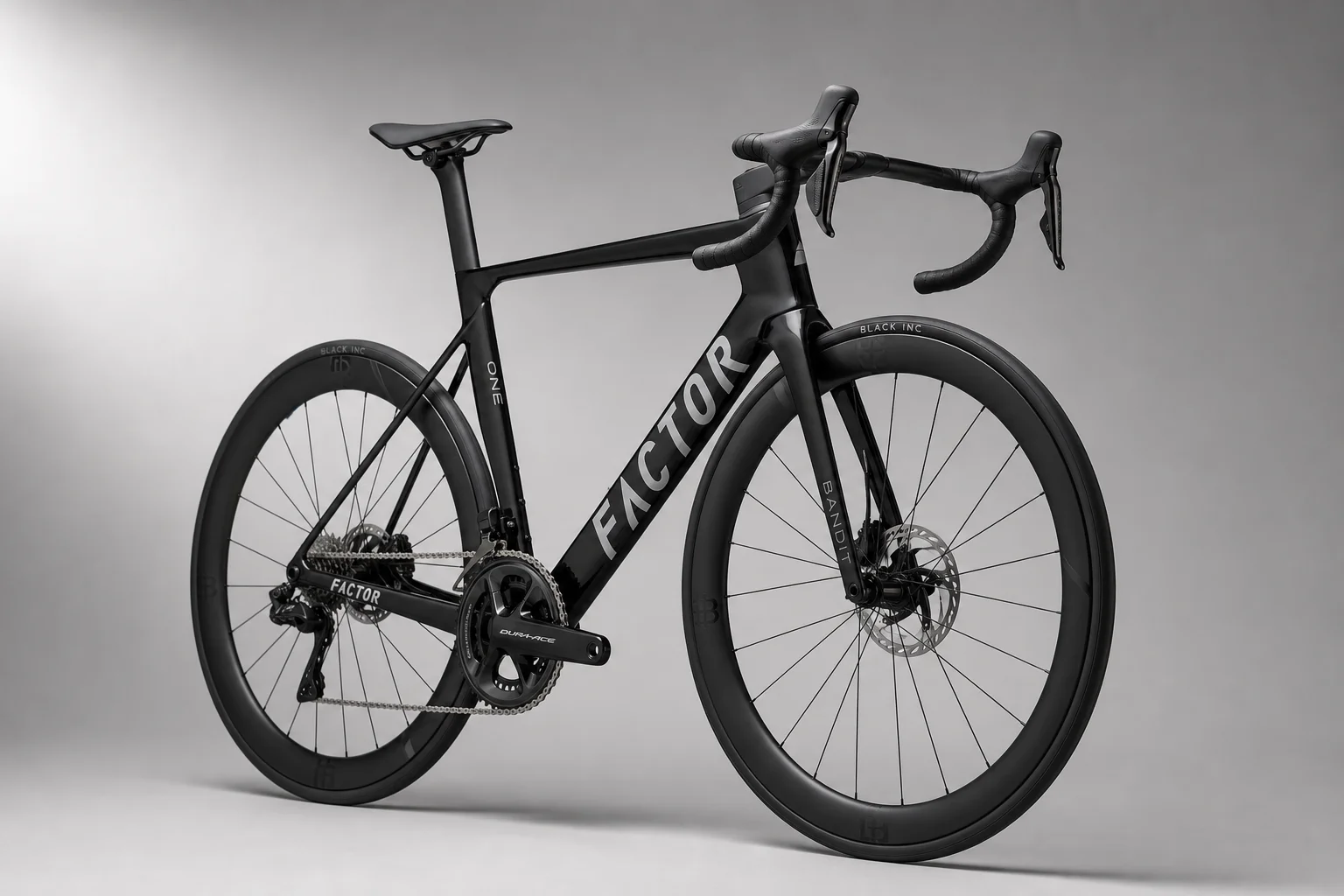 Factor One aero road bike in black with distinctive thin Bandit fork and integrated handlebars on grey backdrop