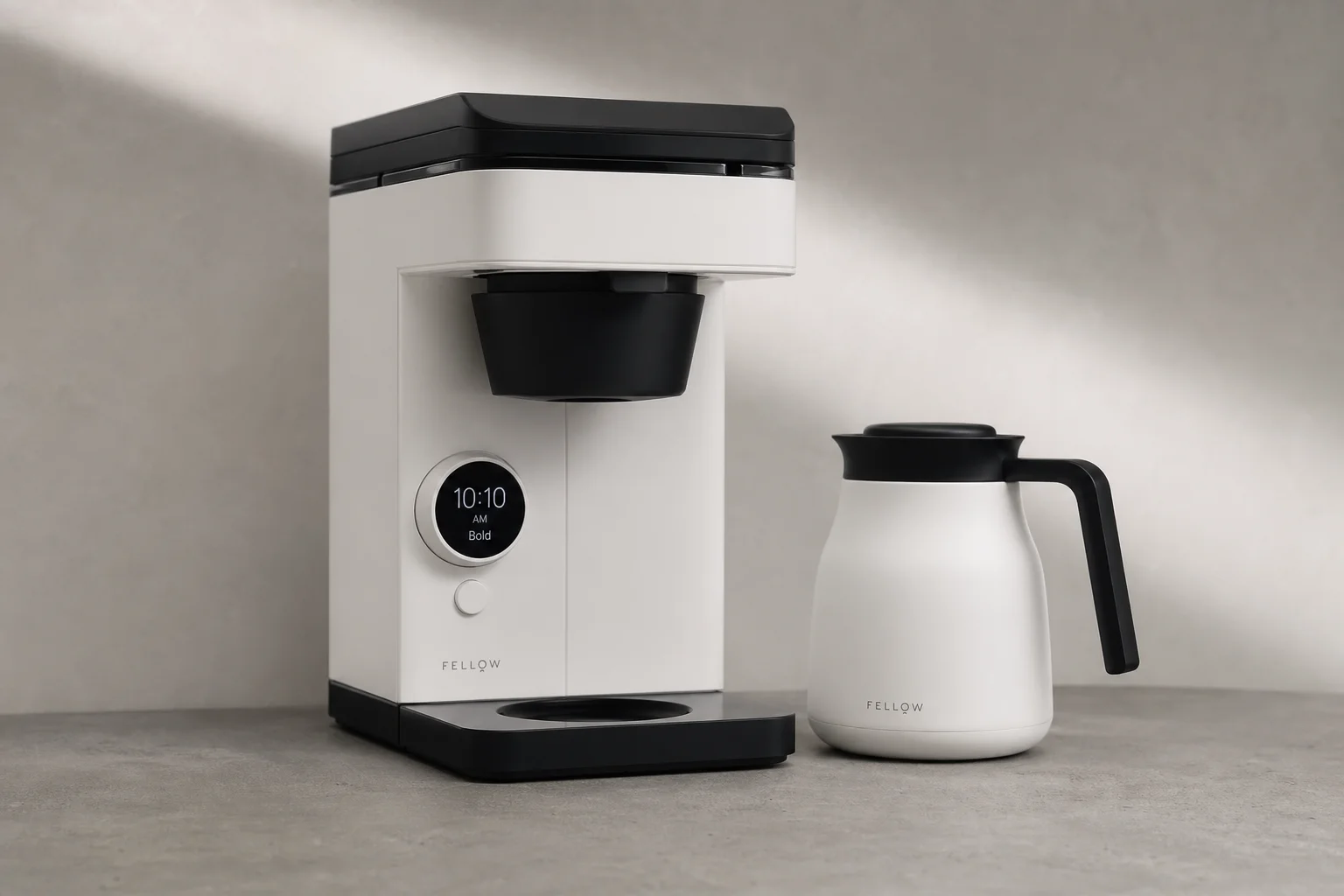 Fellow Aiden coffee maker with thermal carafe on concrete surface