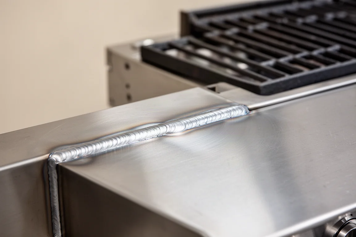 Stainless steel surface showing clean weld and polished finish after grinding