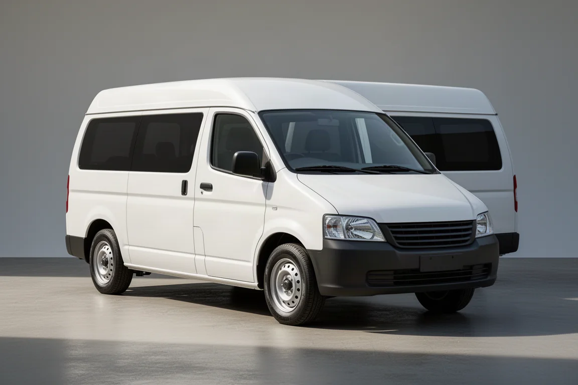 Plain white low-roof van with tinted windows on a neutral grey backdrop