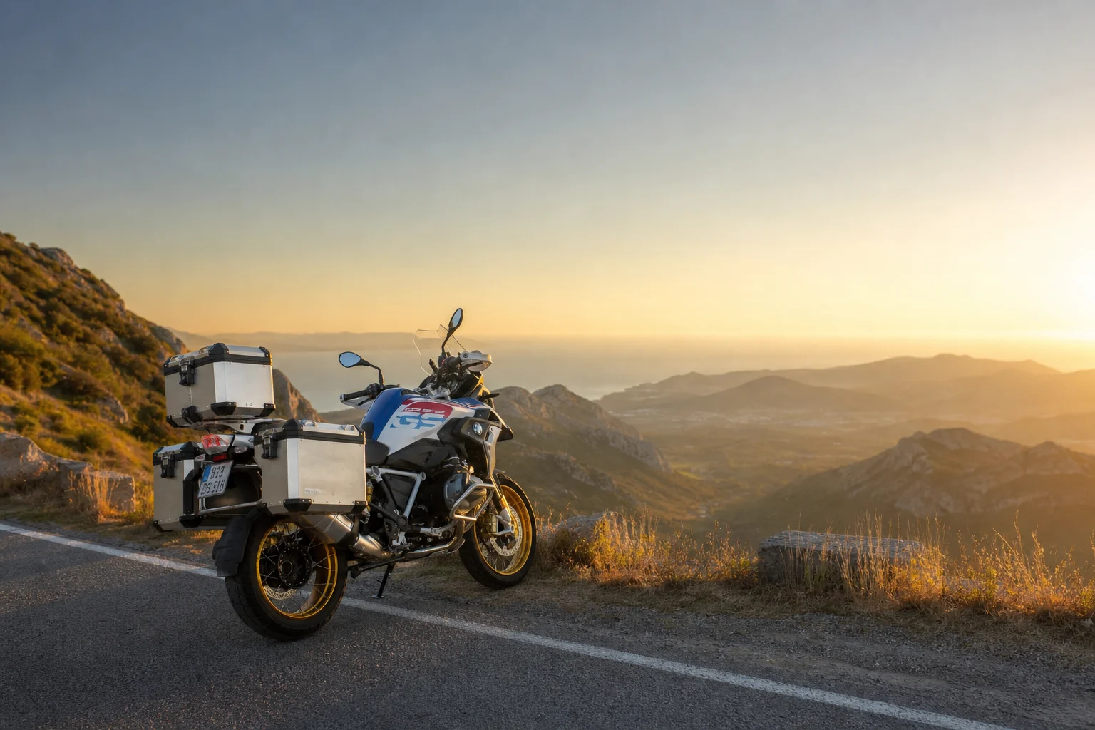 Adventure motorcycle parked on mountain road with scenic landscape backdrop