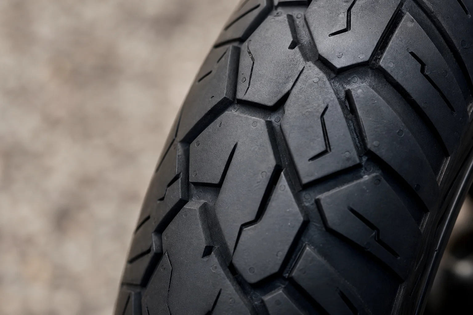 Close-up of motorcycle tire tread showing puncture resistance and durability