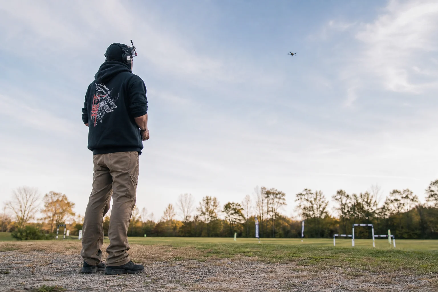 FPV pilot at outdoor flying location holding transmitter