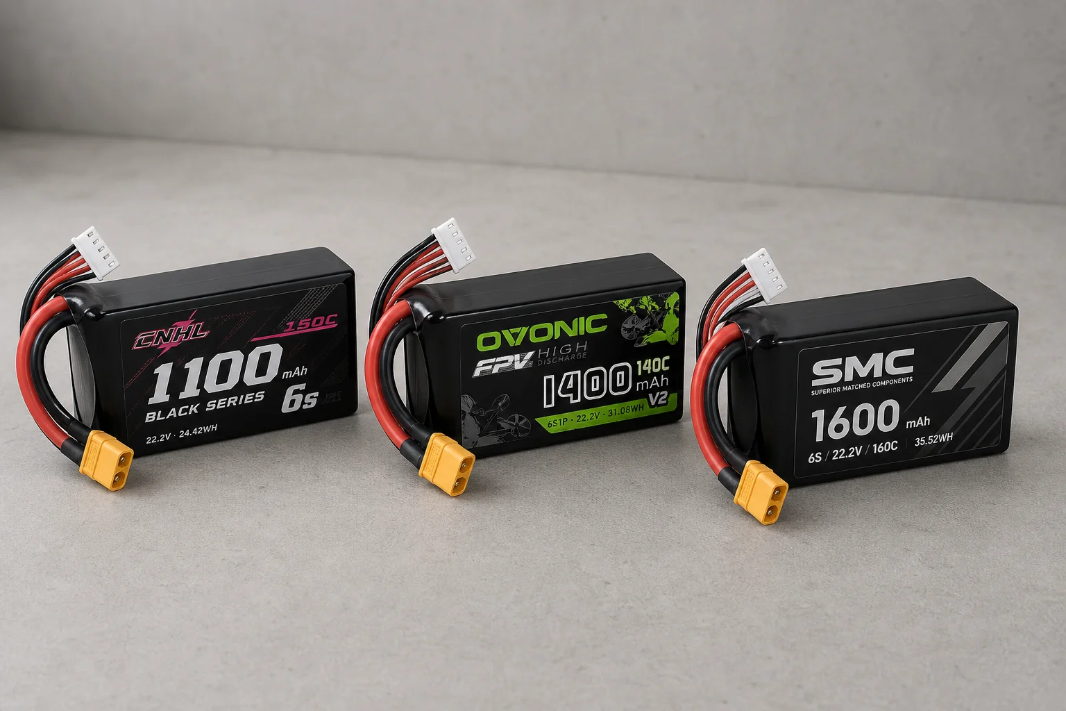 Three LiPo battery packs arranged on concrete surface showing CNHL, Ovonic, and SMC models