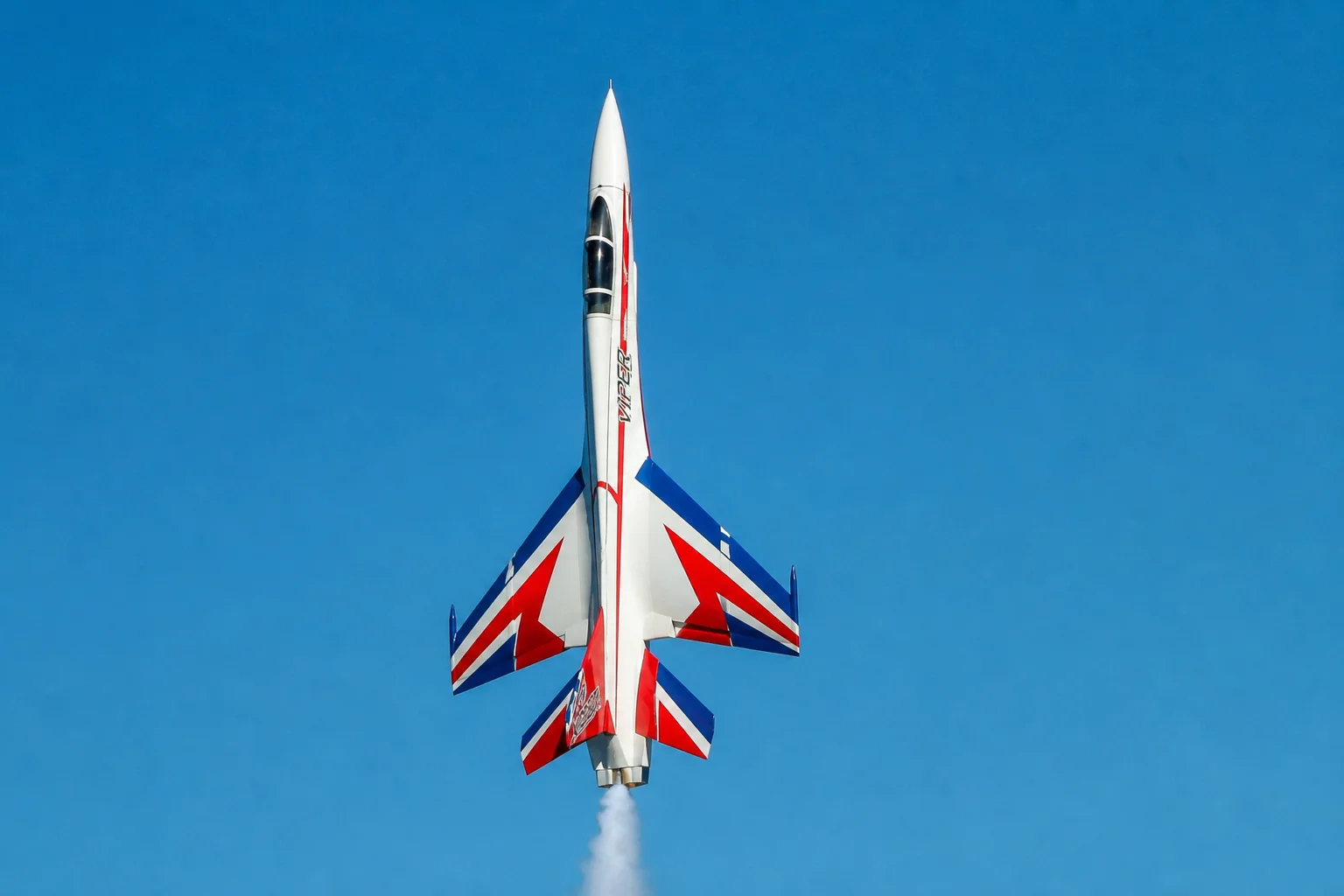 RC jet performing high-speed vertical climb maneuver