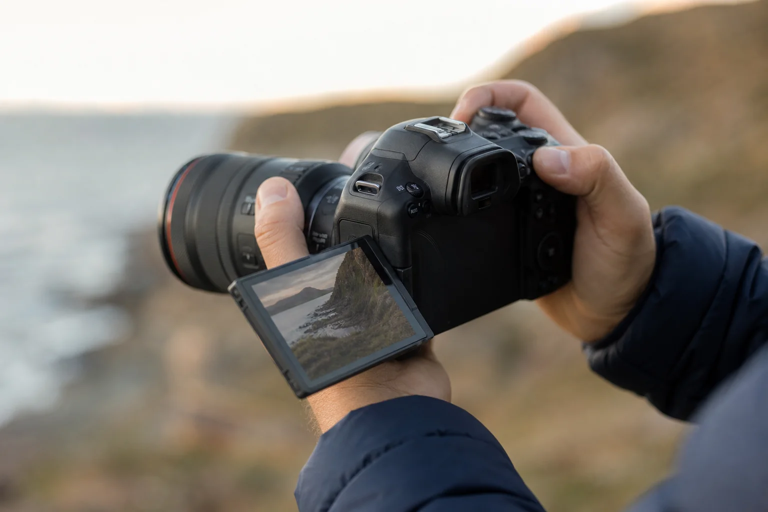 Photographer reviewing images on camera LCD screen in outdoor setting