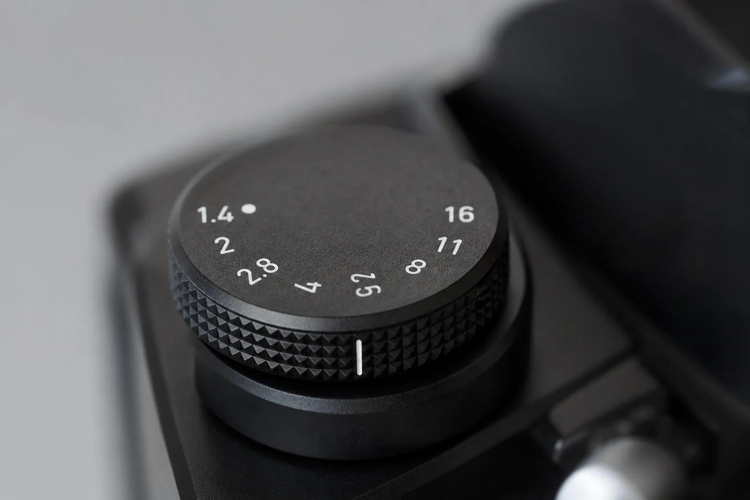 Close-up of camera aperture dial showing manual f-stop markings