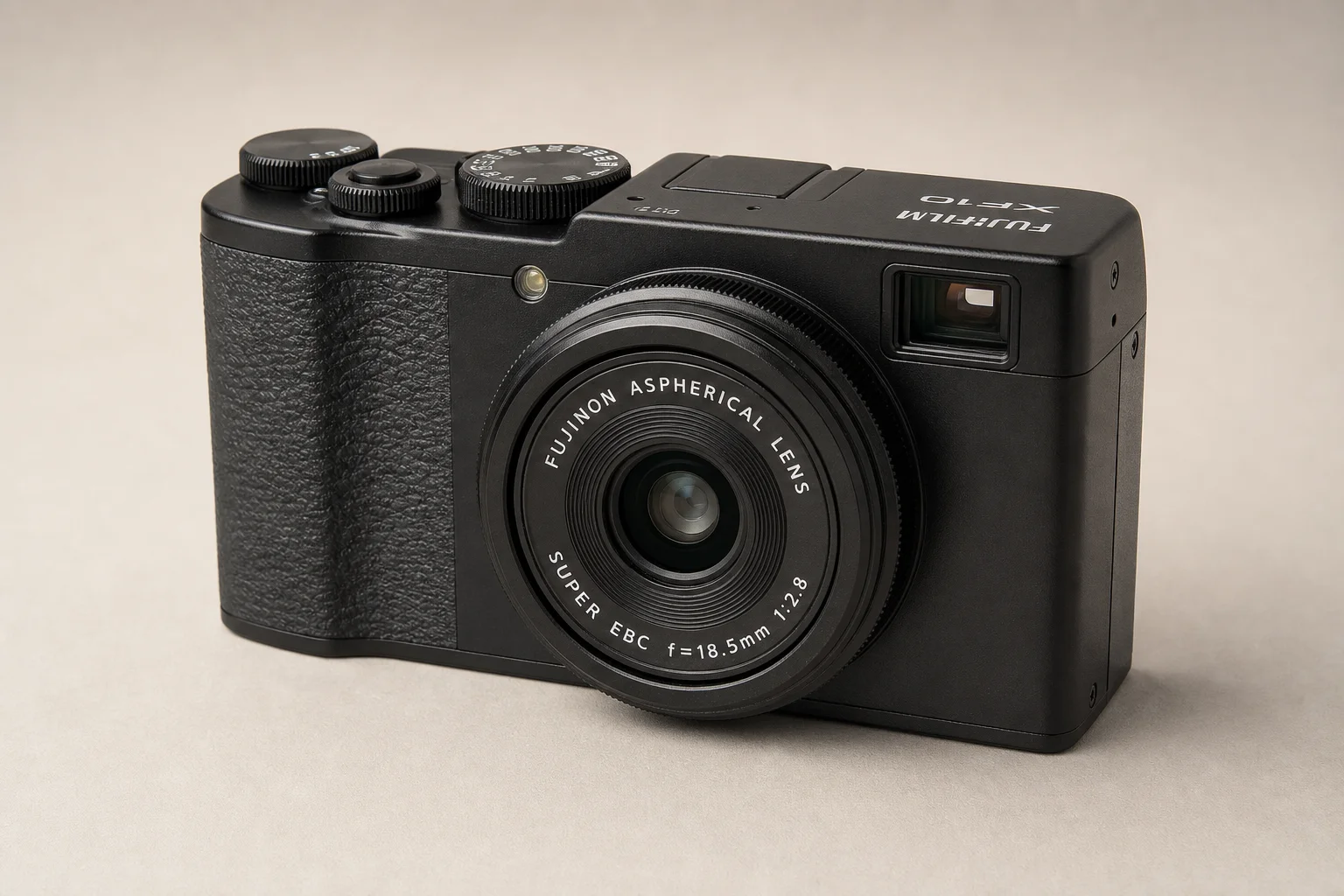 Six compact cameras arranged on concrete surface showing different designs and features