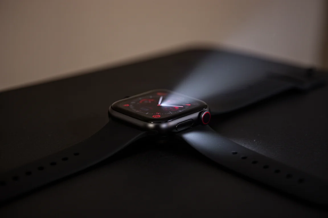Watch flashlight casting a warm beam across a dark surface at night