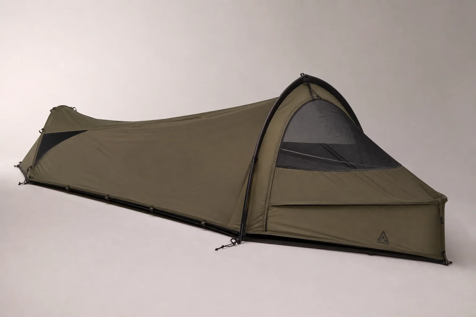 Seven survival tents of varying sizes and styles arranged on neutral backdrop