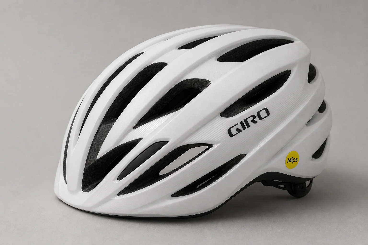 Five road bike helmets arranged in a row on concrete surface showing different designs