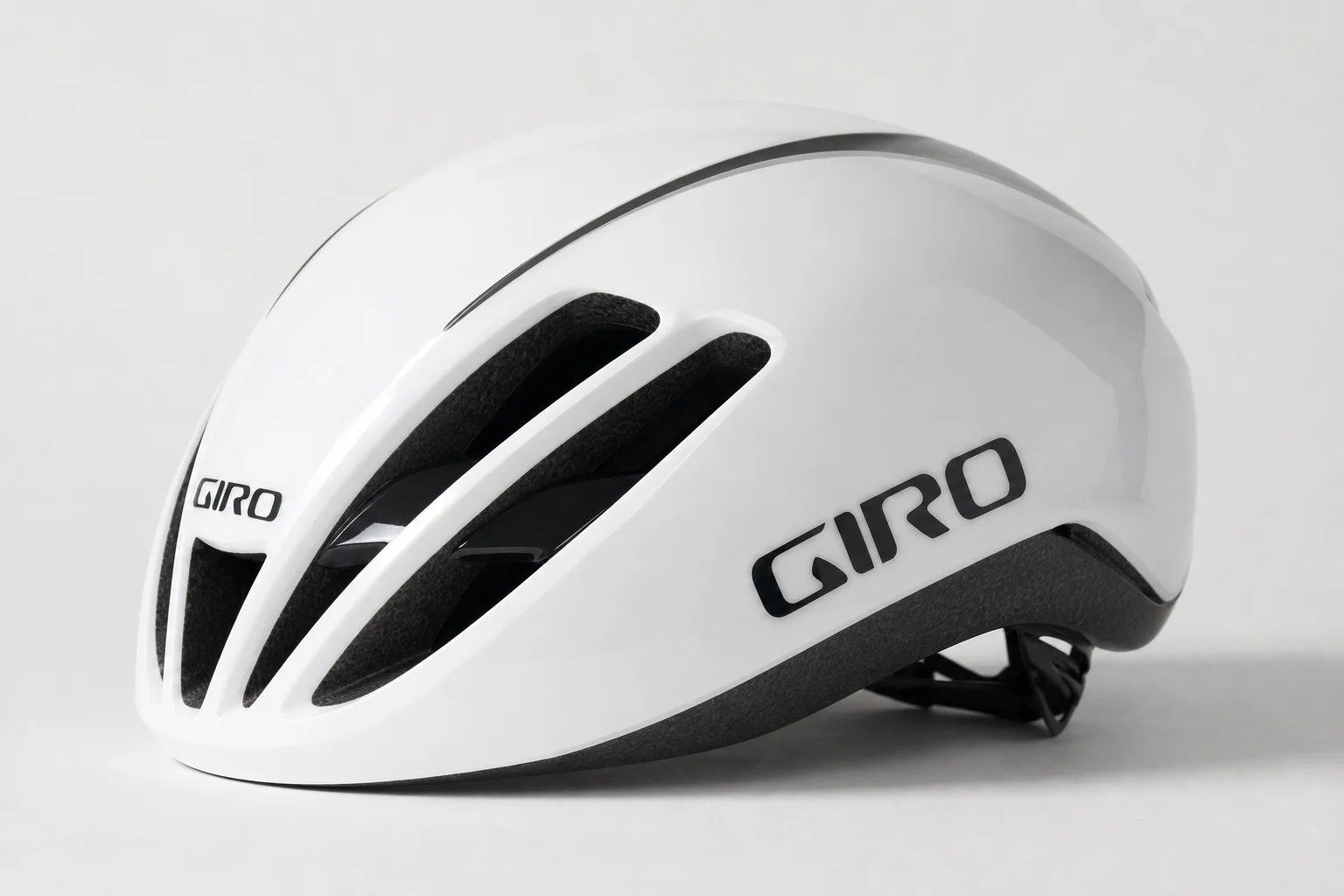 Six aerodynamic road cycling helmets arranged on concrete surface