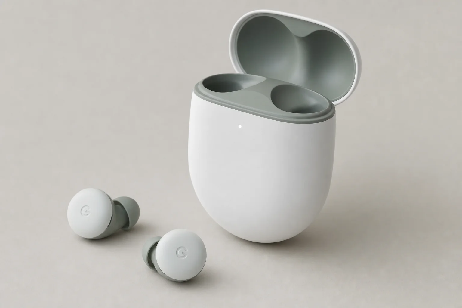 Collection de 12 écouteurs sans fil disposés sur une surface en béton