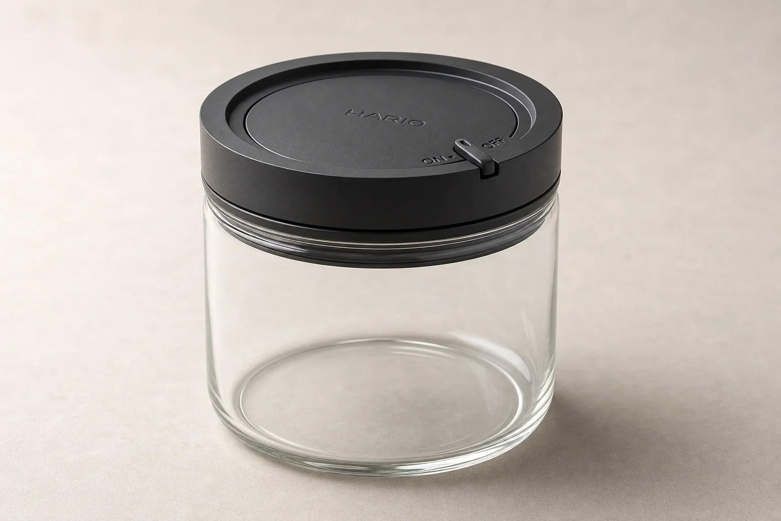 Eleven coffee storage containers arranged by category on concrete surface