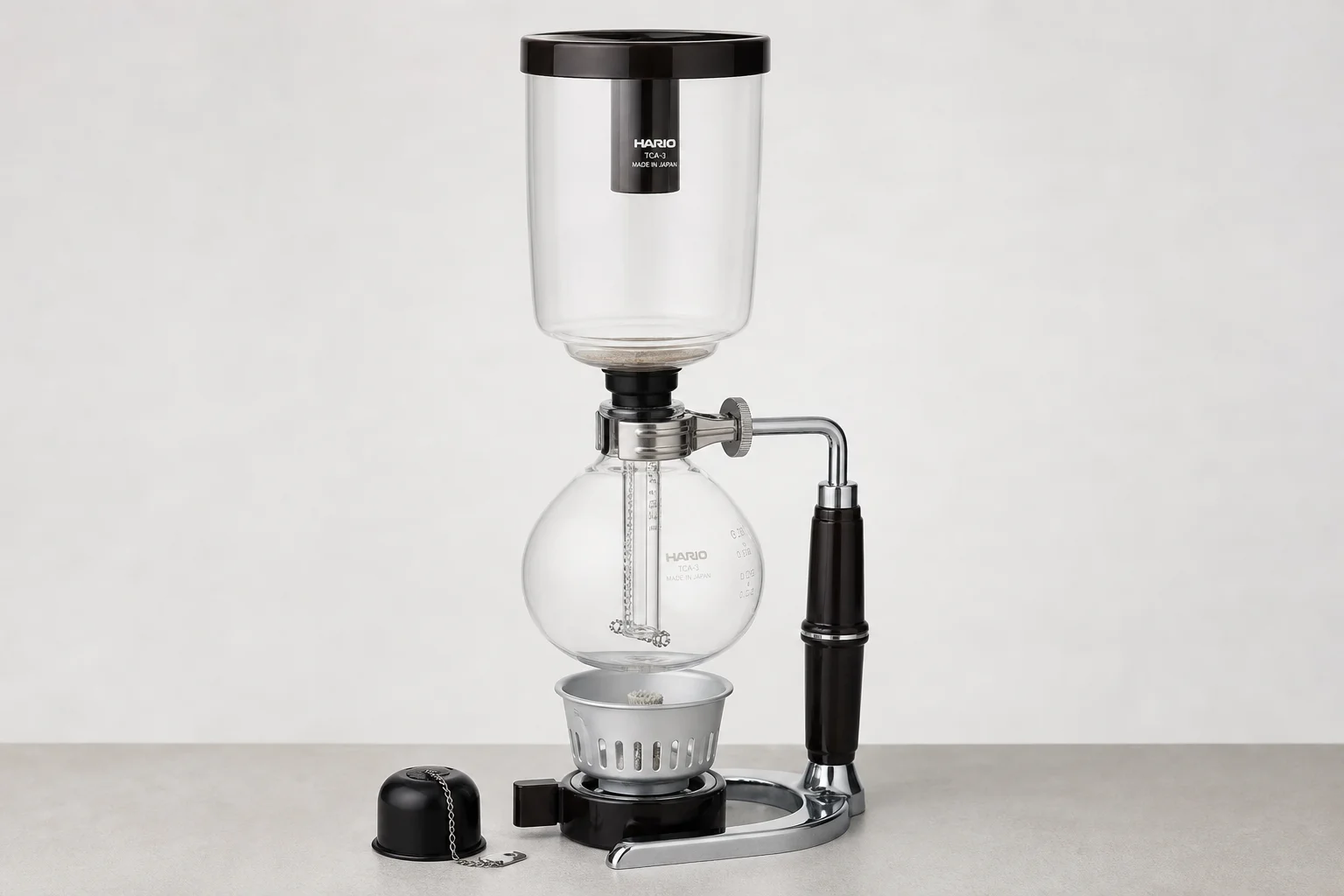 Five vacuum coffee makers displayed on neutral backdrop showing different styles and designs