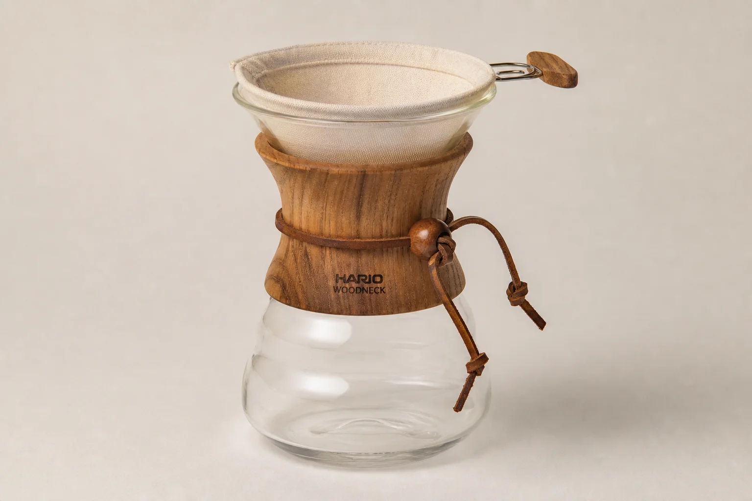 Five pour over coffee makers arranged on concrete surface showing variety of styles and designs