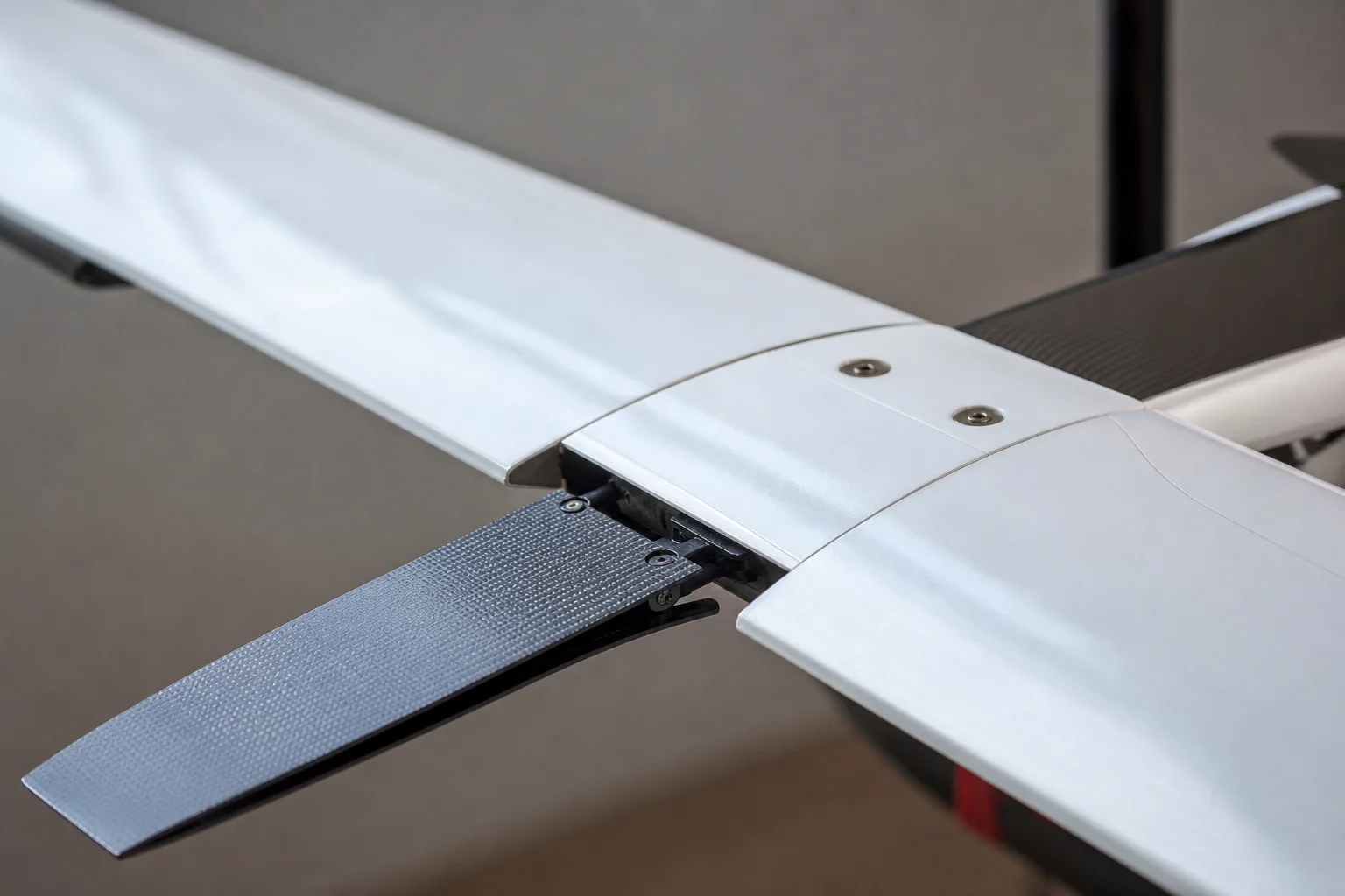 Close-up of RC glider wing joint and spoiler mechanism detail