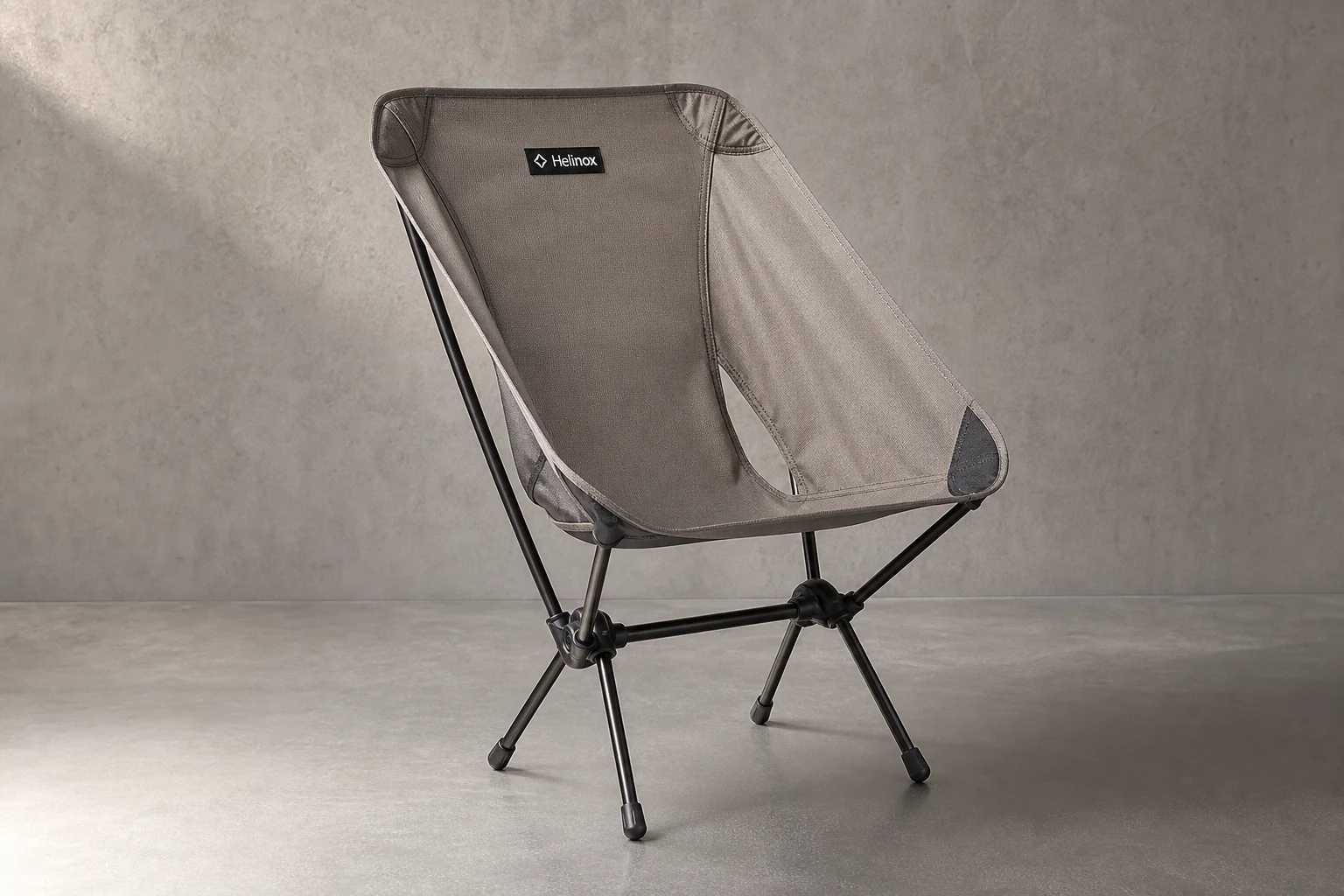 Helinox Chair Zero and REI Co-op Flexlite Air backpacking chairs side by side on neutral backdrop