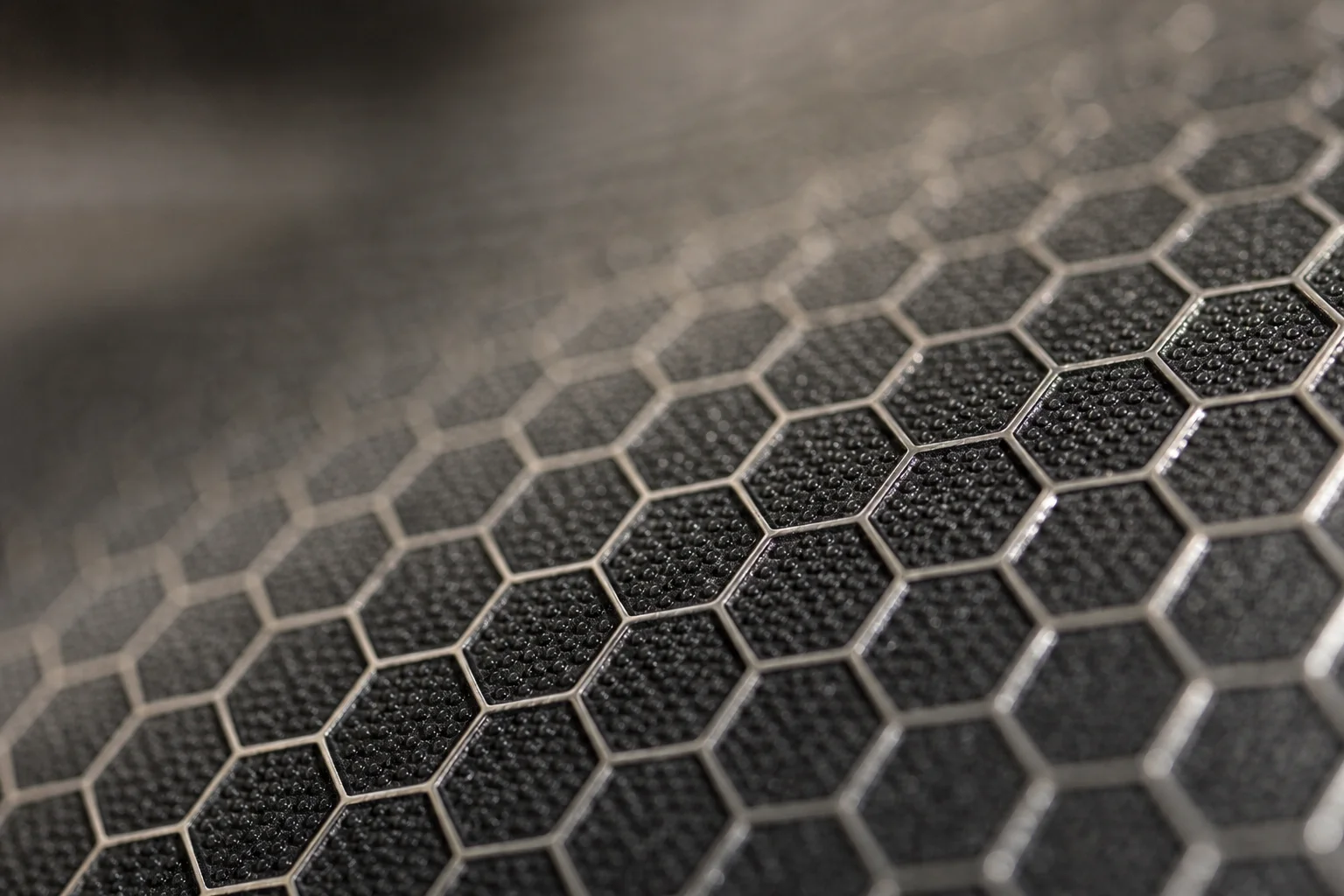 Close-up of hexagonal surface texture on HexClad pan with raised steel peaks