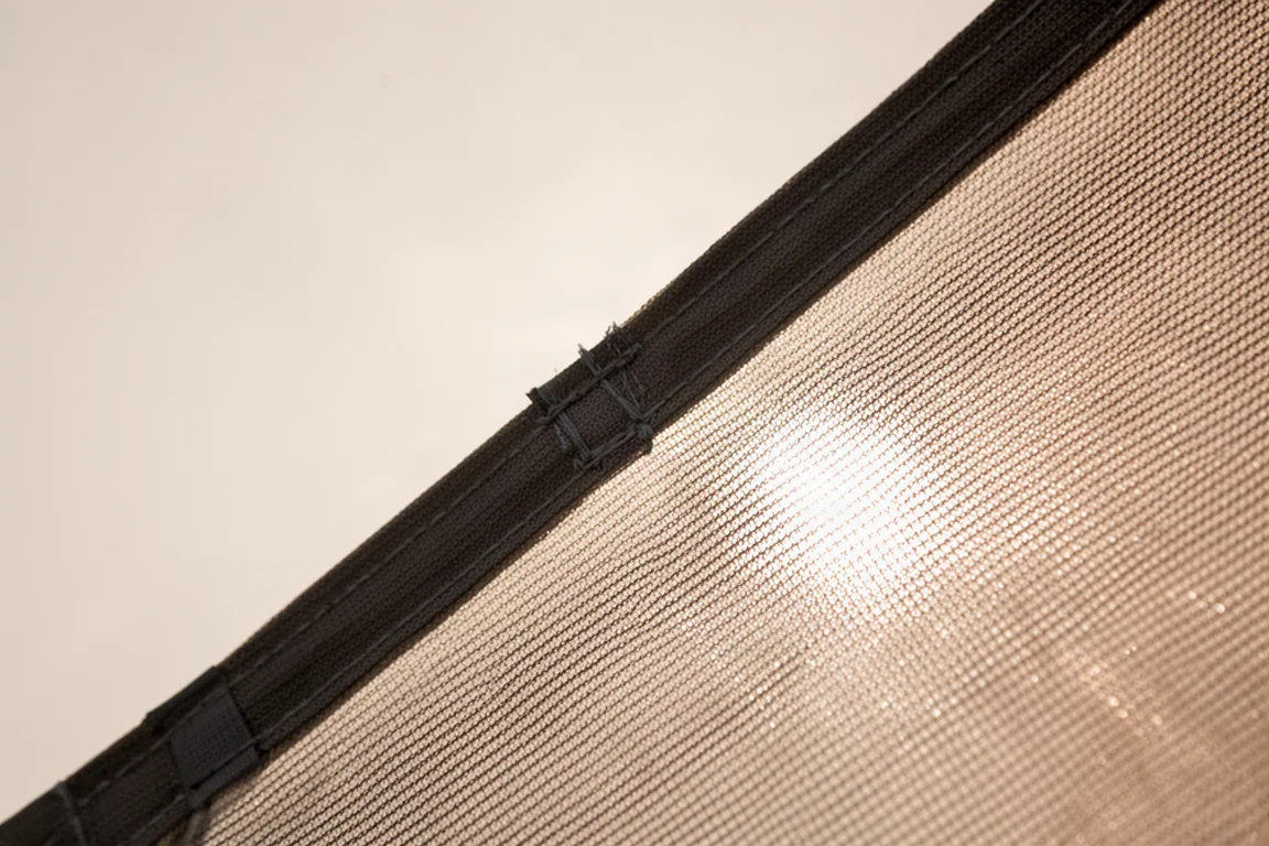 Close-up of fine mesh tent fabric with daylight passing through the weave