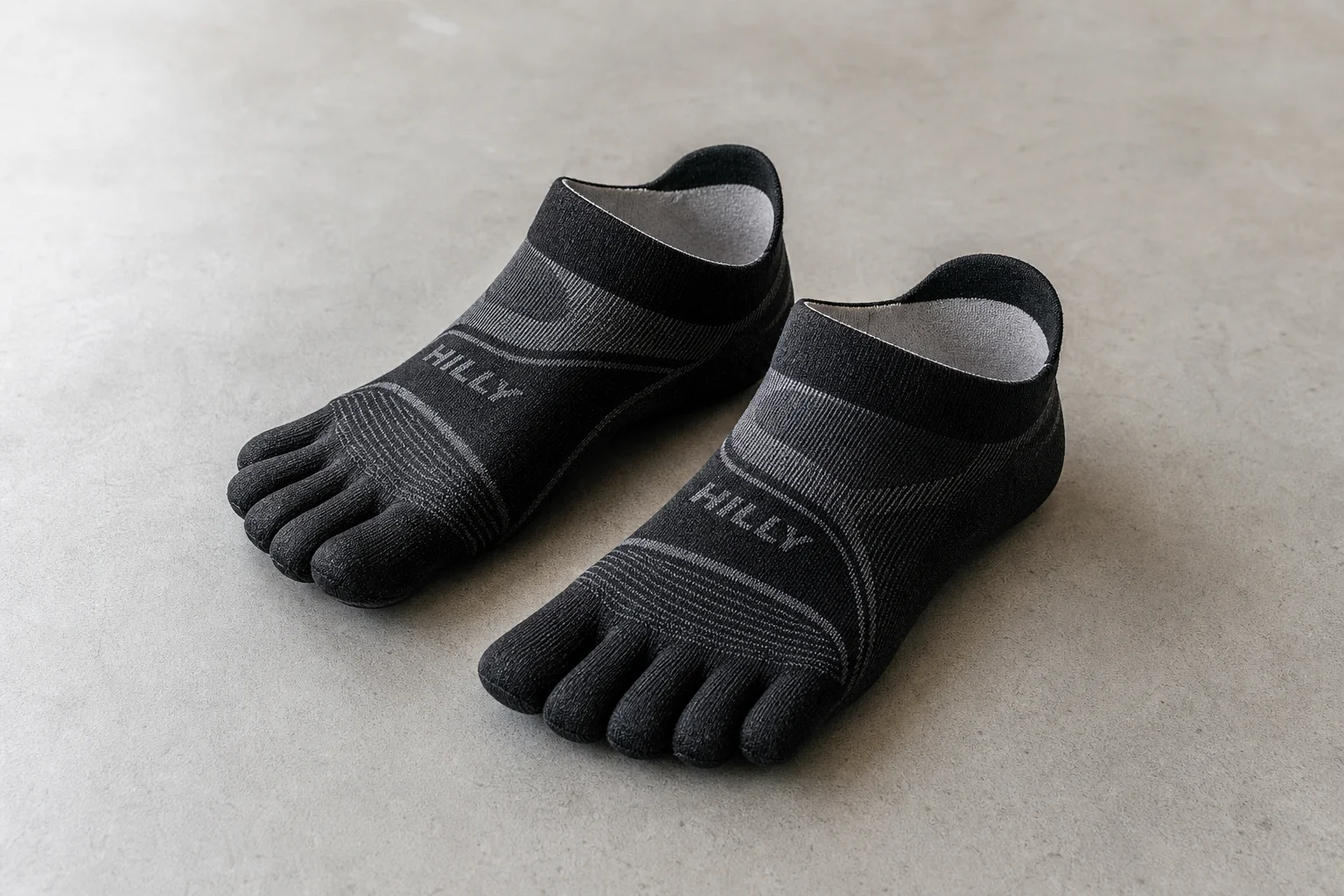 Collection of various running socks in different colors and styles on neutral backdrop
