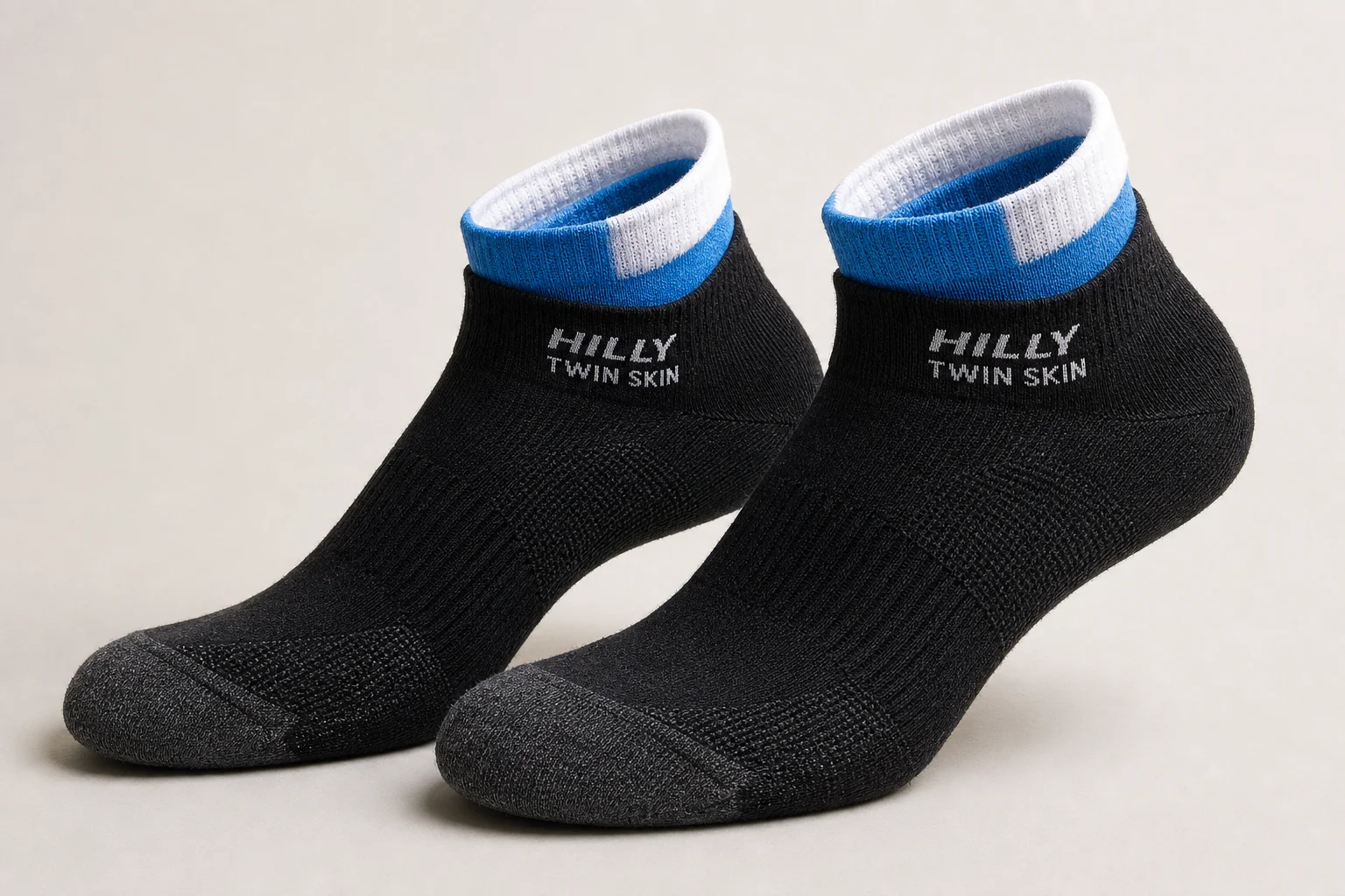 Collection of various running socks in different colors and styles on neutral backdrop
