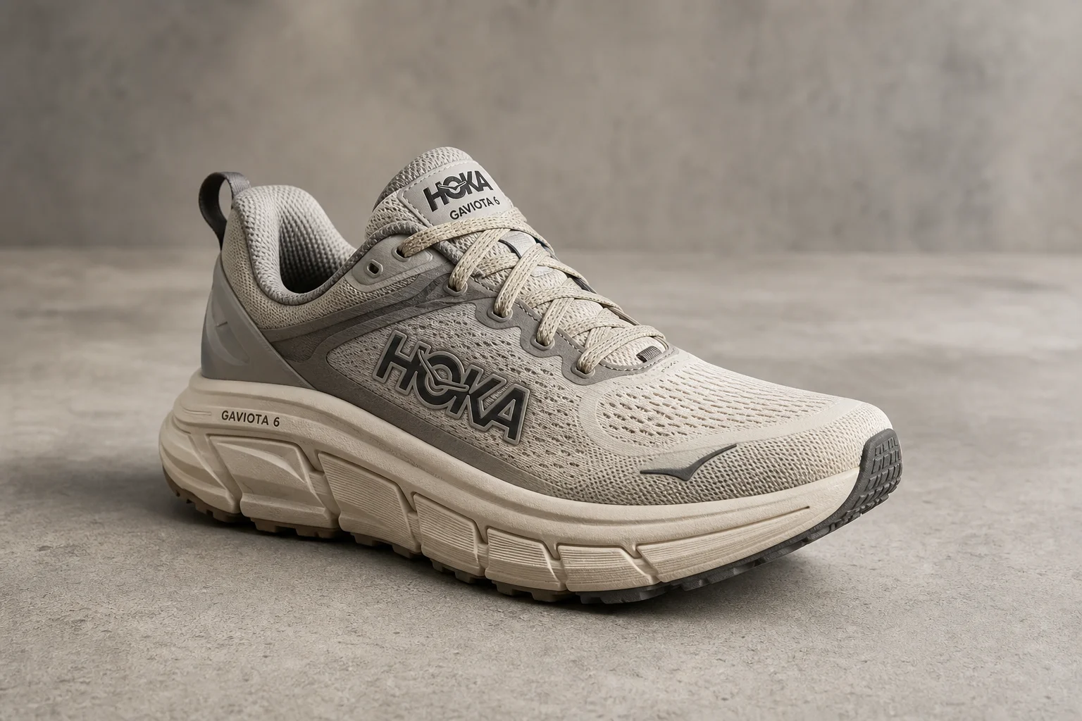 Seven trail running and hiking shoes arranged on concrete surface