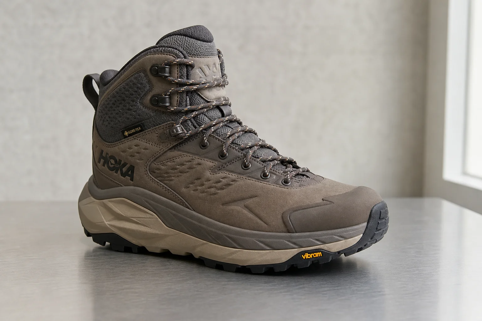 Seven hiking boots arranged on concrete surface representing different styles and purposes