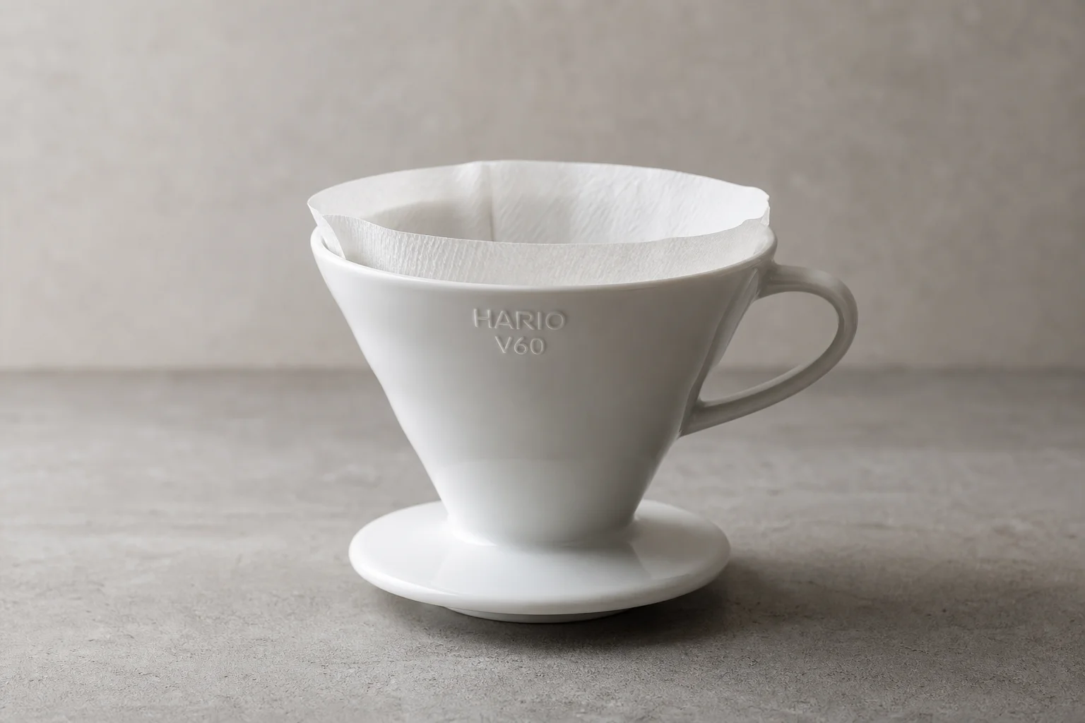Hario V60 ceramic pour-over dripper on concrete surface