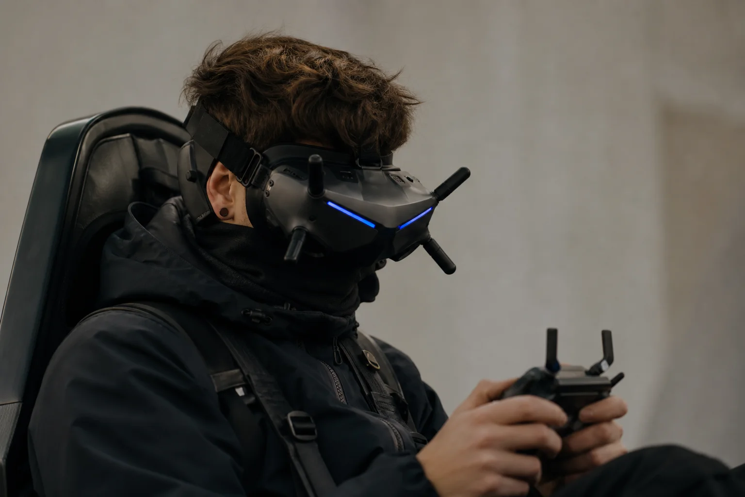 FPV pilot wearing goggles with blue LED strips illuminated
