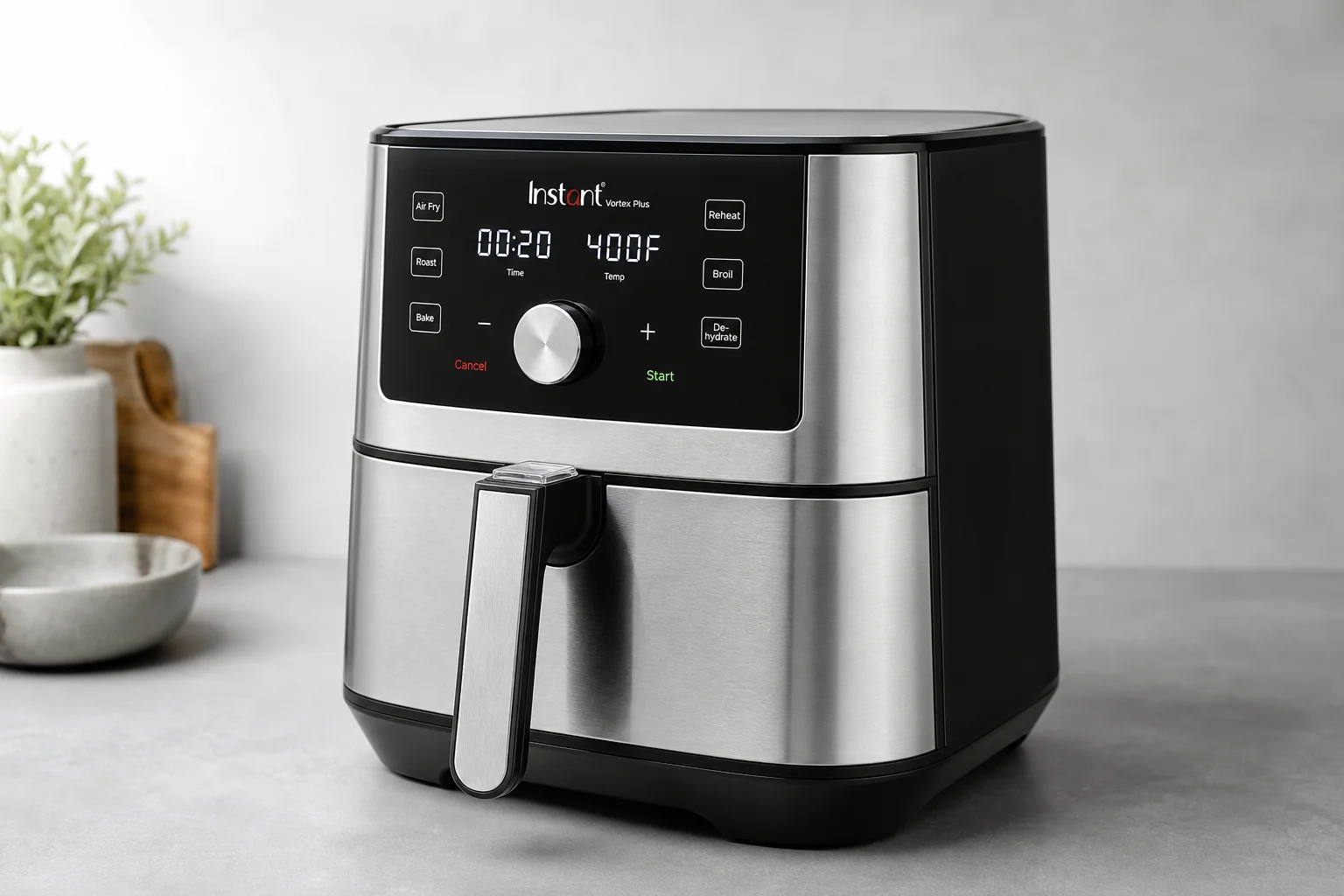 Seven air fryers of varying sizes and designs arranged on a neutral surface