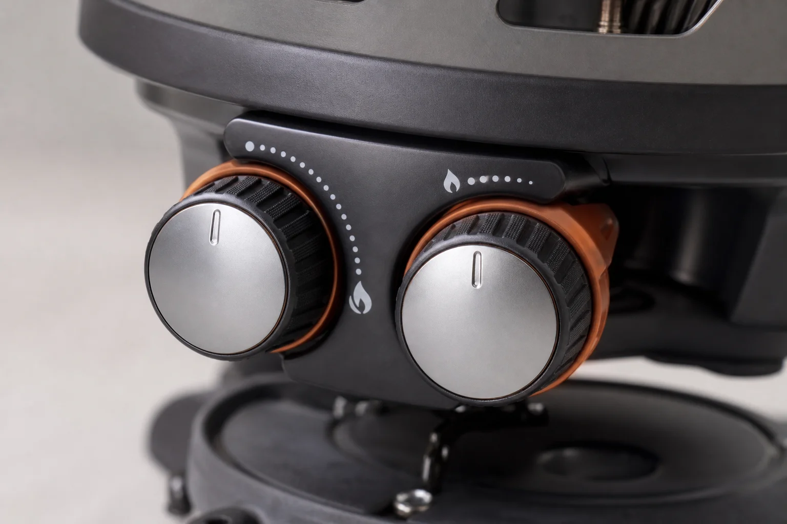 Close-up of Jetboil Genesis burner control knobs showing fine temperature adjustment