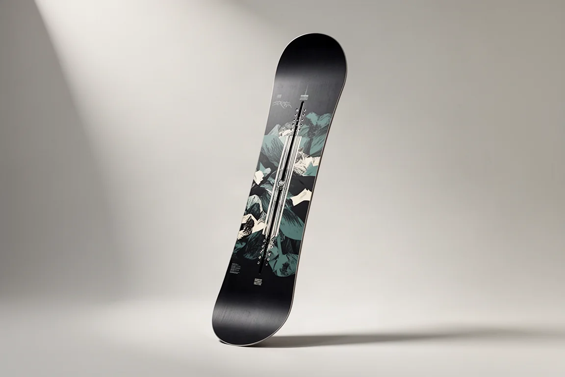 Snowboard standing upright on a neutral grey studio backdrop under soft directional light