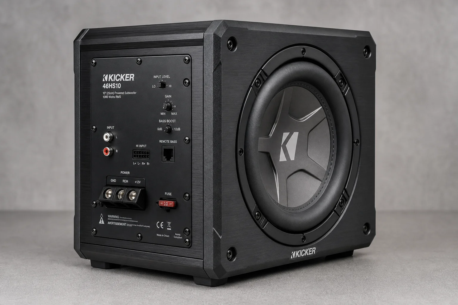 Five compact under-seat subwoofers arranged on dark surface showing various models and sizes