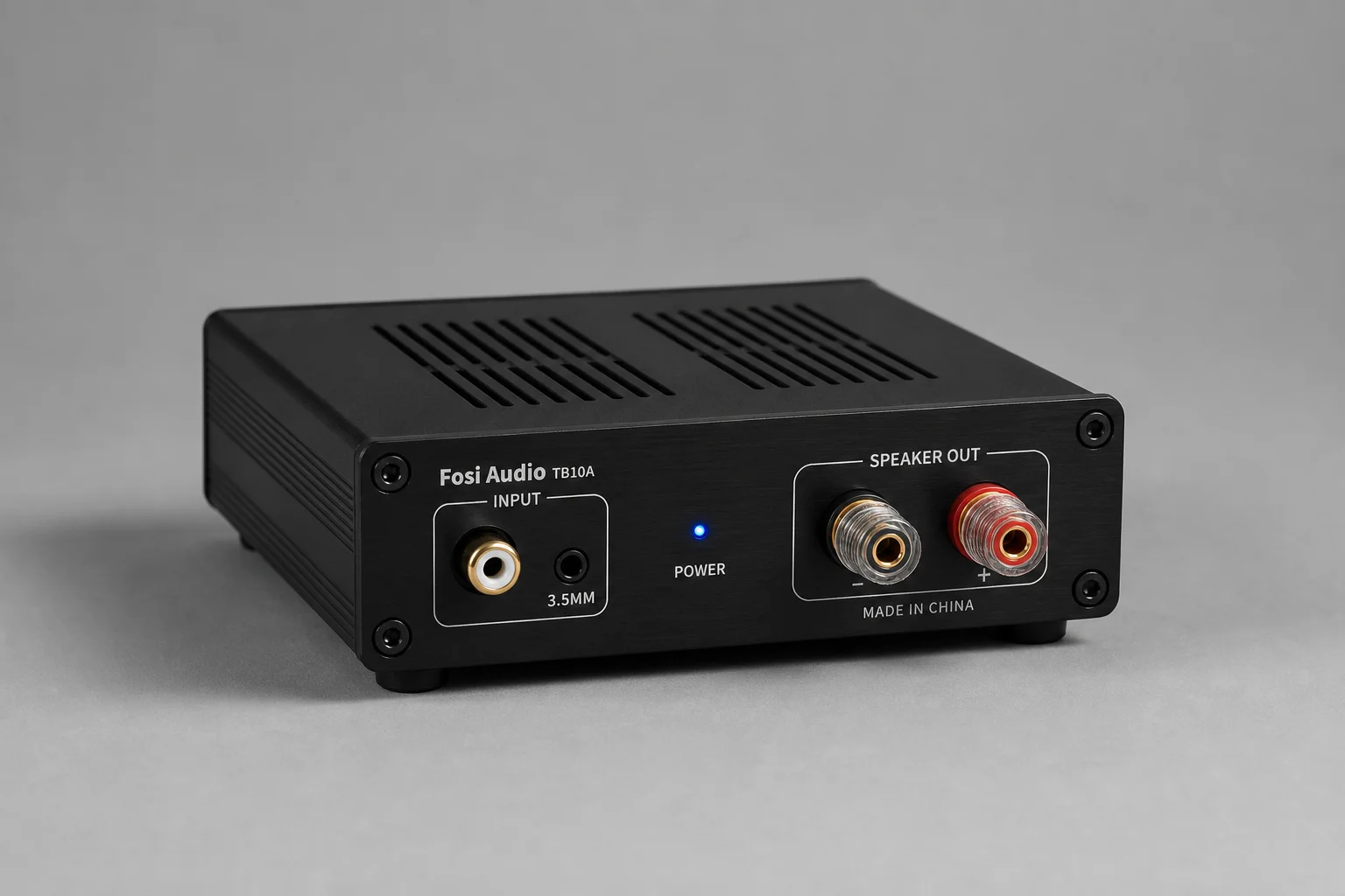 Sette amplificatori mono per auto disposti su una superficie in alluminio spazzolato