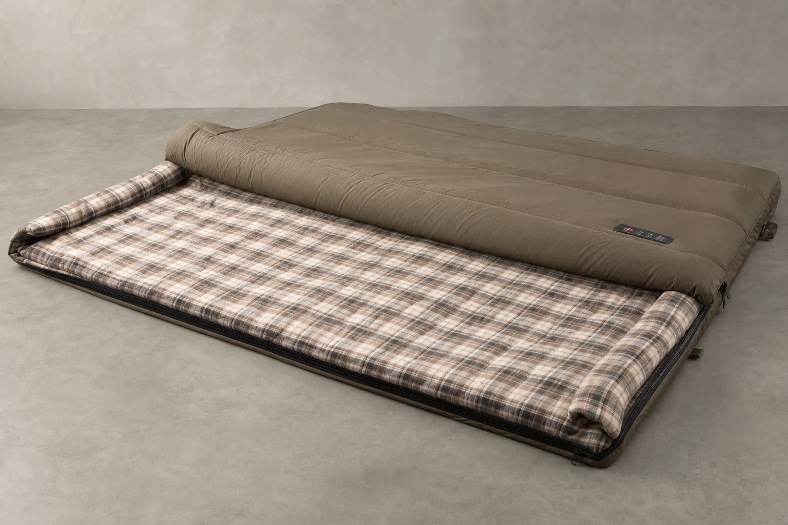Five heated sleeping bags in various styles arranged on concrete surface